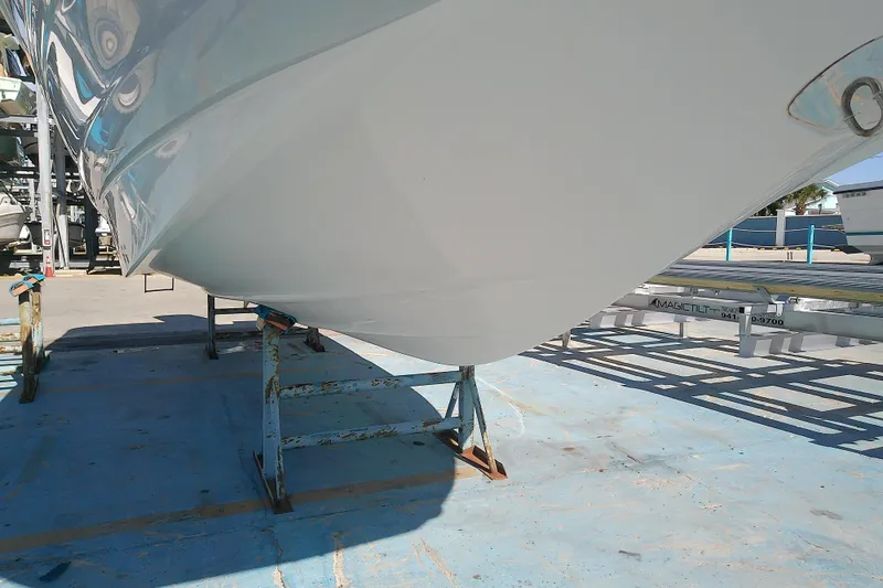 Slide: The Image of 2017 Crownline Eclipse E6 XS boat hull on stands in a marina setting. - 8