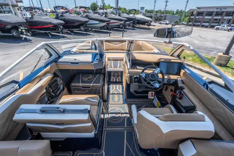 Slide: The Image of Interior of 2026 Tigé Ultré 23ZX boat with luxurious seating and modern dashboard. - 10