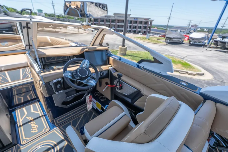 Slide: The Image of 2026 Tigé Ultré 23ZX boat interior with modern dashboard and luxurious seating. - 12