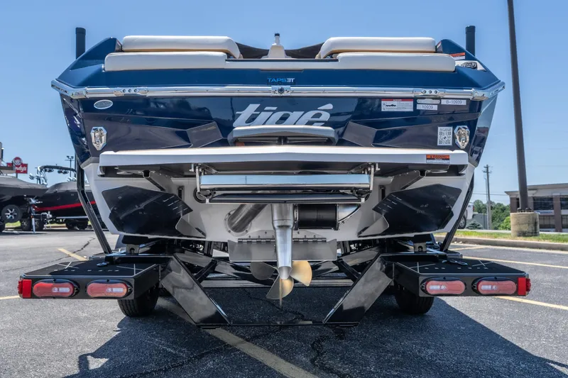 Slide: The Image of Rear view of a 2026 Tigé Ultré 23ZX boat on a trailer in a parking lot. - 13
