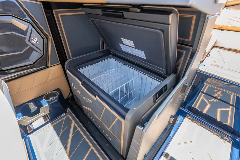 Slide: The Image of 2026 Tigé Ultré 23ZX boat interior with open cooler and stylish design. - 18