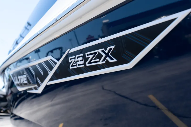 Slide: The Image of 2026 Tigé Ultré 23ZX boat close-up, showcasing sleek design and branding details. - 2