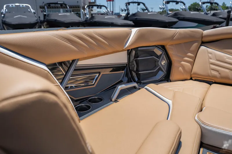 Slide: The Image of Luxurious interior of 2026 Tigé Ultré 23ZX boat with tan leather seating and cup holders. - 21
