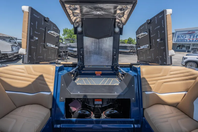 Slide: The Image of 2026 Tigé Ultré 23ZX boat interior with tan seating and open engine compartment. - 28