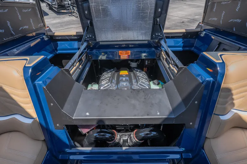 Slide: The Image of 2026 Tigé Ultré 23ZX boat engine compartment with blue and tan interior detailing. - 29