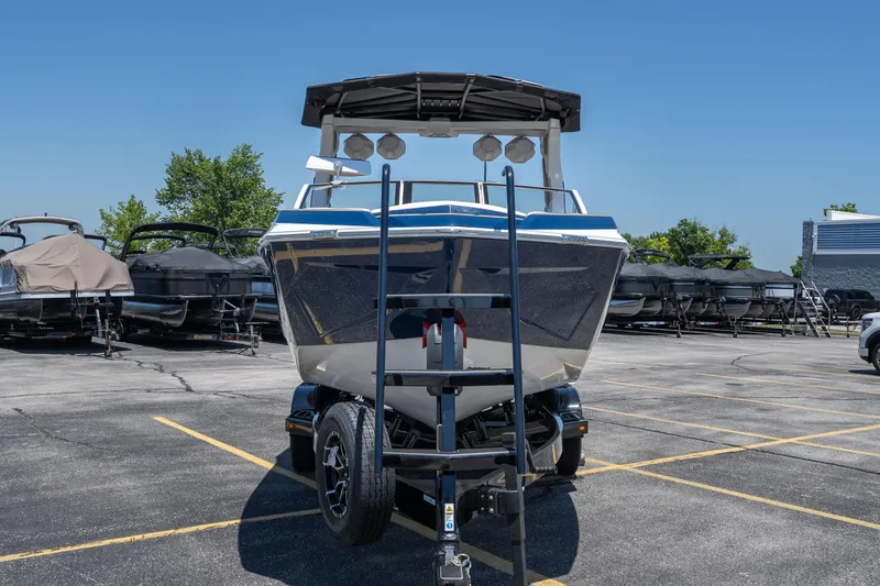 Slide: The Image of 2026 Tigé Ultré 23ZX boat on trailer in parking lot, clear blue sky background. - 3