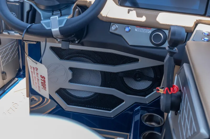 Slide: The Image of 2026 Tigé Ultré 23ZX boat interior with steering wheel and speaker system. - 31