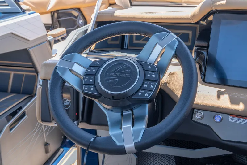 Slide: The Image of Steering wheel of 2026 Tigé Ultré 23ZX boat with control buttons and touchscreen display. - 32