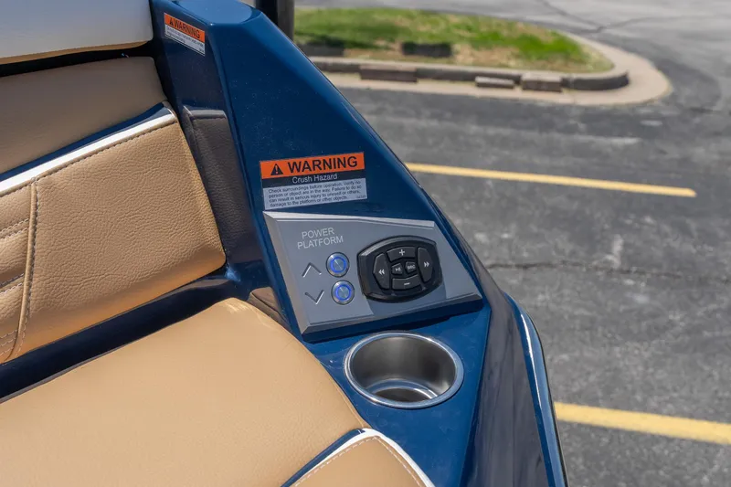 Slide: The Image of Control panel and seating on 2026 Tigé Ultré 23ZX boat, featuring warning label and cup holder. - 34