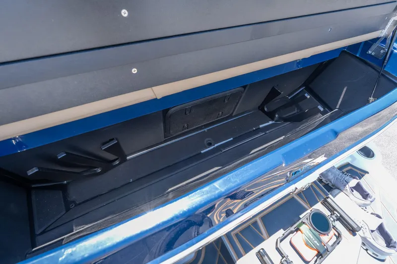 Slide: The Image of Open storage compartment in 2026 Tigé Ultré 23ZX boat, showcasing spacious interior design. - 35