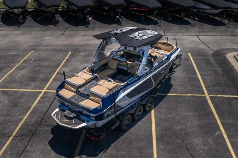 Slide: The Image of 2026 Tigé Ultré 23ZX boat in parking lot, showcasing sleek design and luxurious seating. - 36