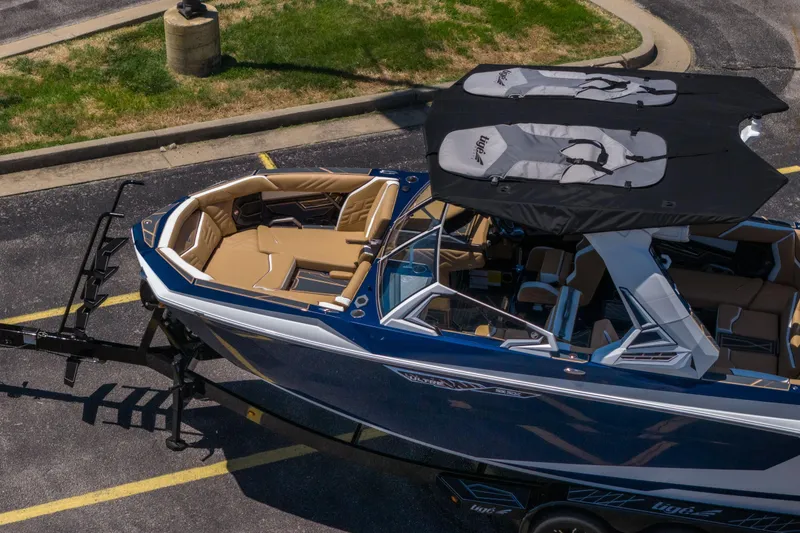 Slide: The Image of 2026 Tigé Ultré 23ZX boat with sleek design and spacious interior, parked on a trailer. - 38