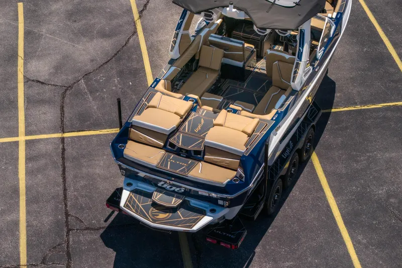 Slide: The Image of 2026 Tigé Ultré 23ZX boat with luxurious seating, parked in a lot. - 39