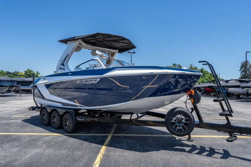 Slide: The Image of 2026 Tigé Ultré 23ZX boat on trailer, sleek design, parked outdoors. - 4