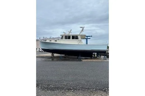 The Image of A 2016 Flowers 43 boat on a dry dock under a cloudy sky. - 0