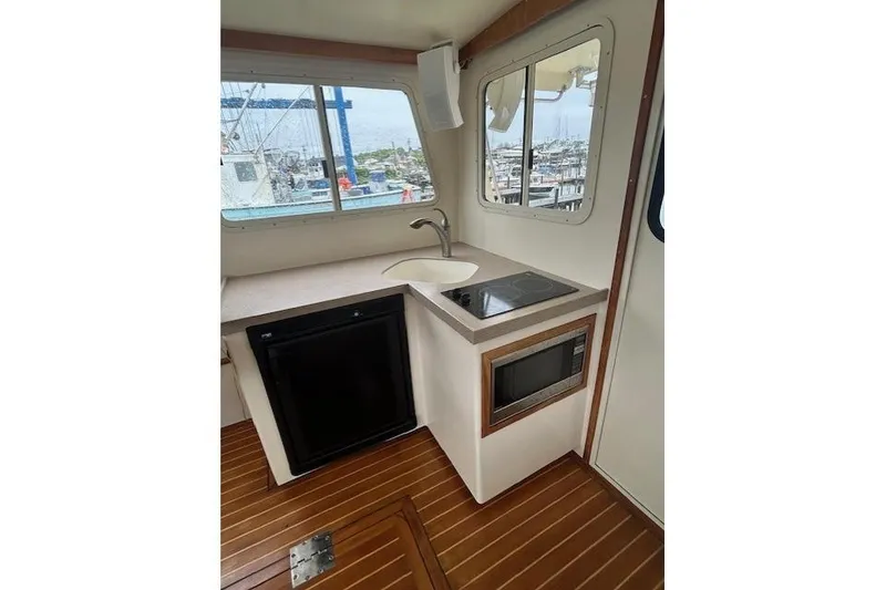 Slide: The Image of Compact boat kitchen with sink, stove, microwave, and wooden flooring, model Flowers 43, 2016. - 11