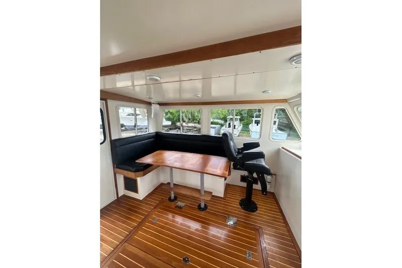 Slide: The Image of Interior of a 2016 Flowers 43 boat with wooden flooring and seating area. - 13