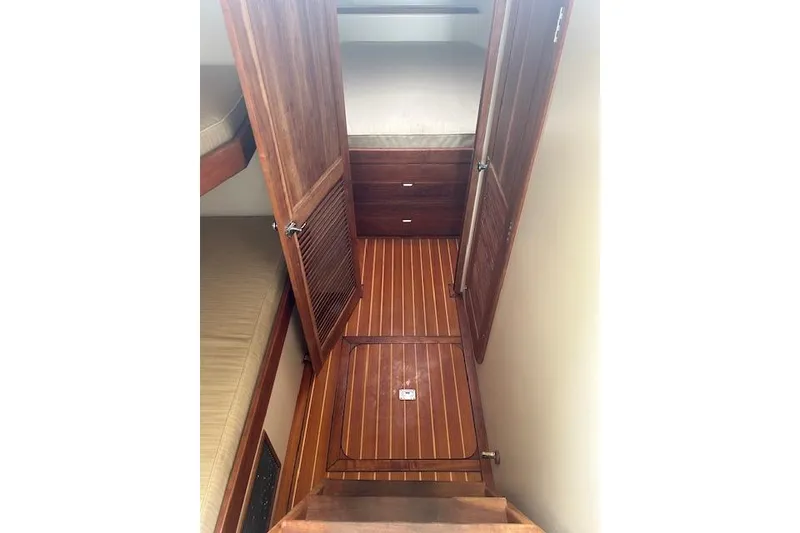 Slide: The Image of Wooden interior of a 2016 Flowers 43 boat, featuring a cabin with bunks. - 17