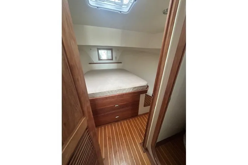 Slide: The Image of Small boat cabin with wooden flooring, bed, and storage drawers, model Flowers 43, 2016. - 19