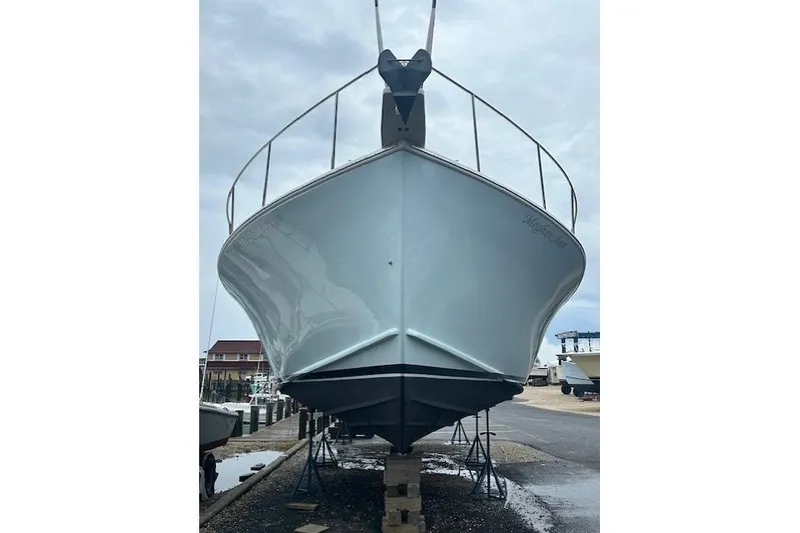 Slide: The Image of Front view of a 2016 Flowers 43 boat on dry dock, overcast sky. - 2