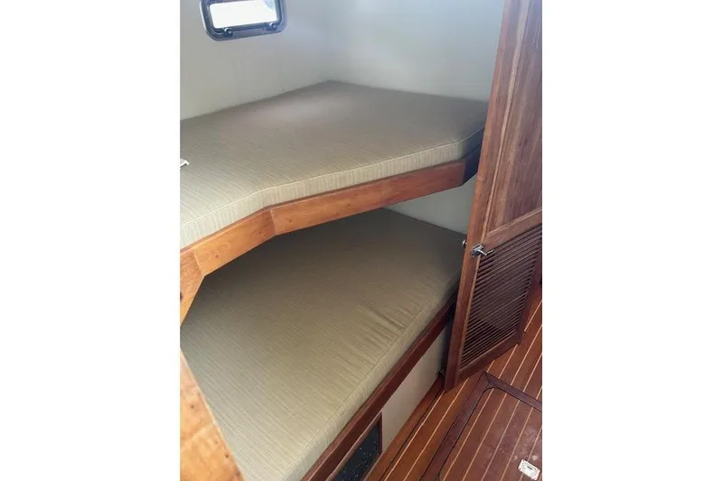 Slide: The Image of Compact wooden bunk beds in a 2016 Flowers 43 boat cabin interior. - 22