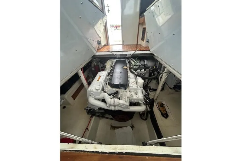 Slide: The Image of Engine compartment of a 2016 Flowers 43 boat, showcasing a clean, well-maintained engine. - 24
