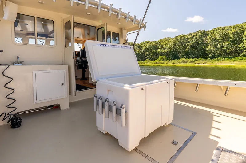 Slide: The Image of Open cooler on a boat deck with scenic river and forest view. - 12