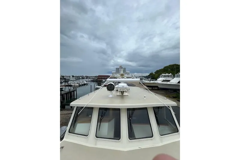 Slide: The Image of Boat deck view with overcast sky, marina in background, Flowers model 43, 2016. - 28