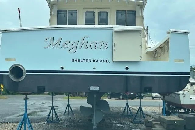 Slide: The Image of Boat named "Meghan" on stands, Shelter Island, NY, overcast day. - 3