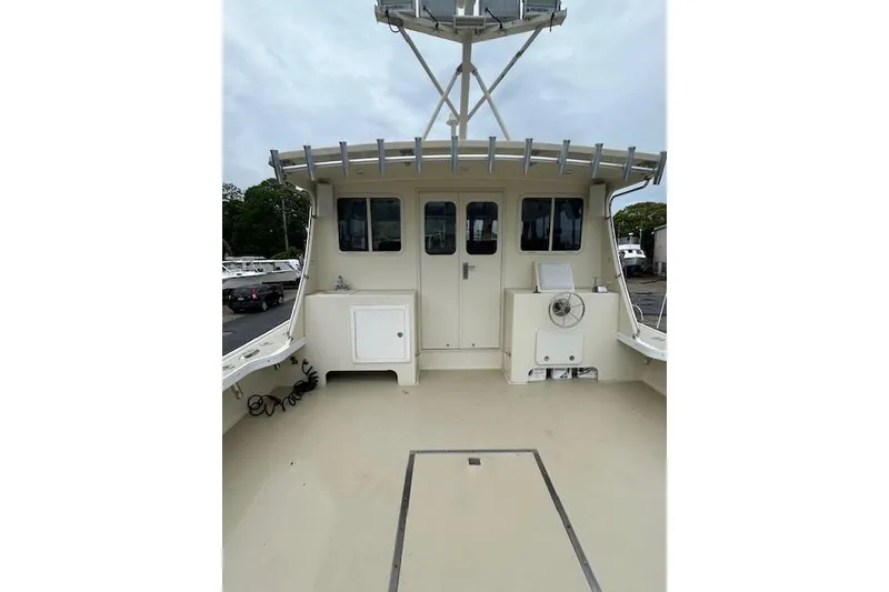 Slide: The Image of Deck view of a 2016 Flowers 43 boat, featuring spacious layout and cabin access. - 4