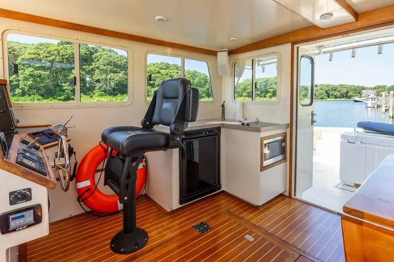 Slide: The Image of Interior of 2016 Flowers 43 boat with helm, seating, and scenic water view. - 28