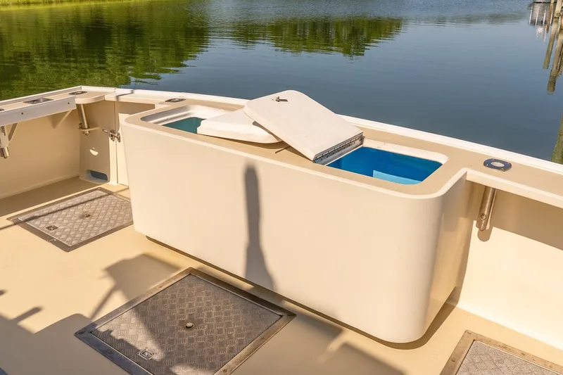 Slide: The Image of Open deck of a 2016 Flowers 43 boat with storage compartments and water view. - 5