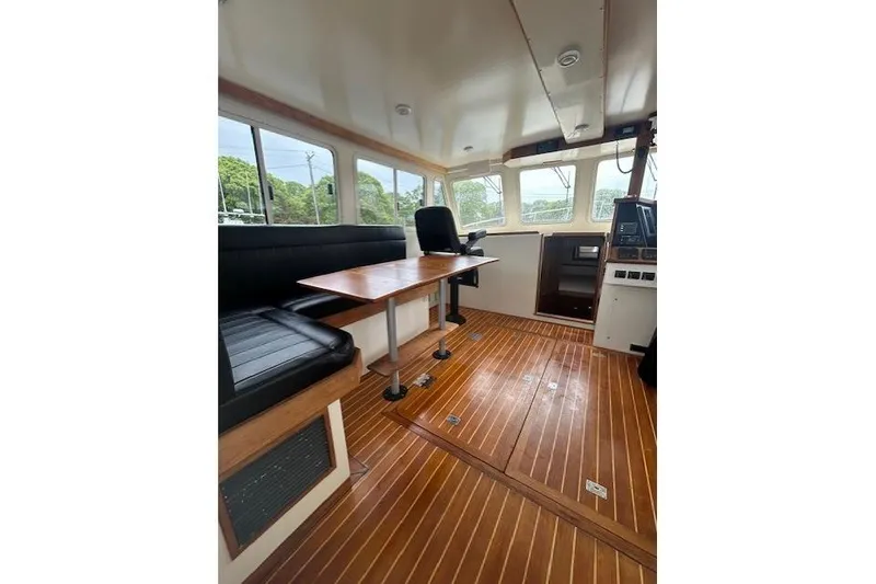 Slide: The Image of Interior of a 2016 Flowers 43 boat with wooden flooring and seating area. - 7