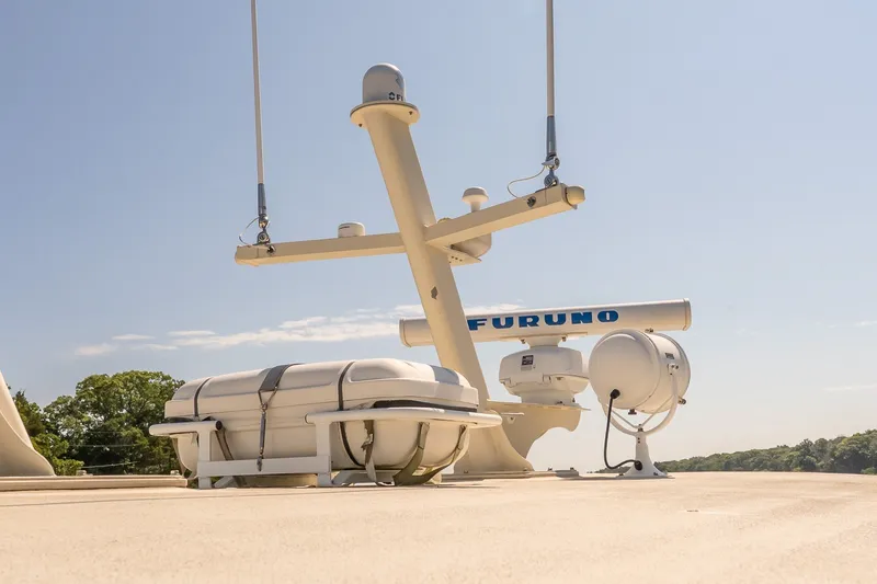 Slide: The Image of Boat deck with radar equipment and life raft under clear blue sky. - 16