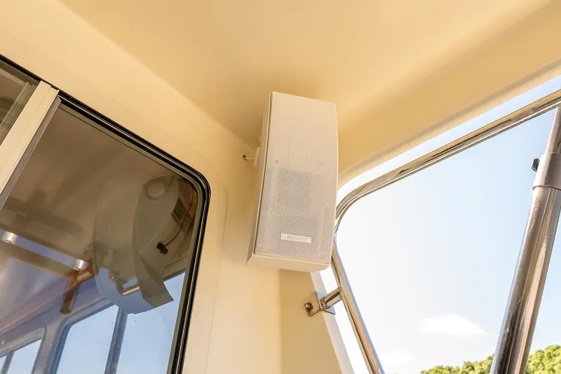Slide: The Image of Boat interior with mounted speaker, window view, and clear sky. Flowers 43, 2016 model. - 24