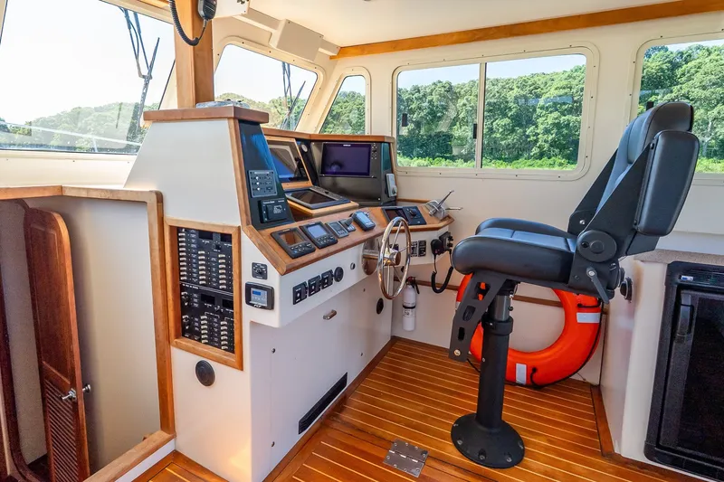 Slide: The Image of Boat cockpit interior with navigation equipment, steering wheel, and captain's chair, model Flowers 43, 2016. - 29