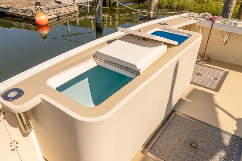 Slide: The Image of Boat deck with open storage compartments, docked near wooden pier, sunny day. - 6