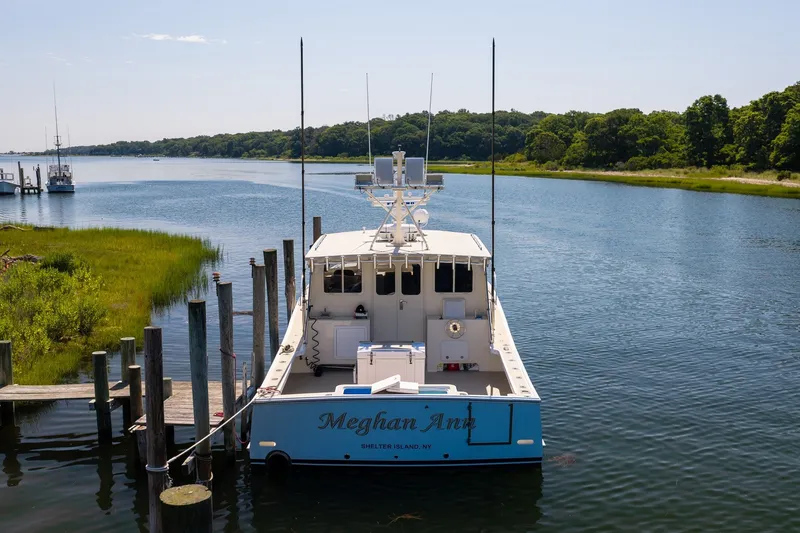 Slide: The Image of A boat named "Meghan Ann" docked in a serene river setting, surrounded by lush greenery. - 4
