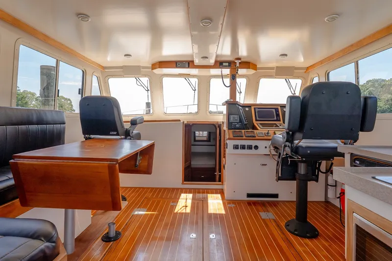 Slide: The Image of Interior of a 2016 Flowers 43 boat with wooden flooring and modern navigation equipment. - 33
