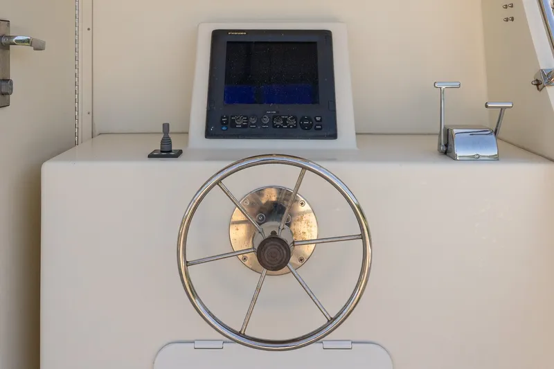 Slide: The Image of Boat steering wheel and control panel on a 2016 Flowers 43 model. - 17