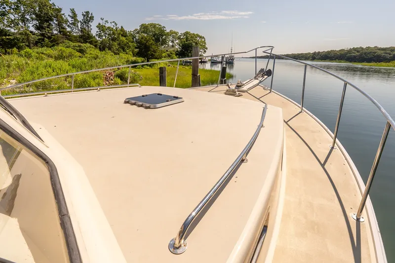 Slide: The Image of Bow of a 2016 Flowers 43 boat docked by a serene riverbank. - 20