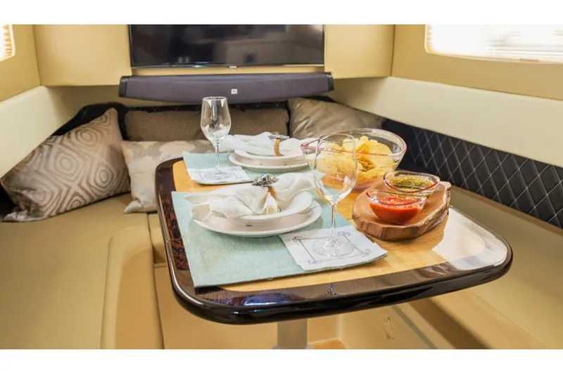 Slide: The Image of Manufacturer Provided Image: Luxurious dining setup inside 2018 Scout 420 LXF yacht with snacks and drinks. - 11