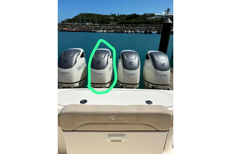 Slide: The Image of Four Suzuki 350 outboard motors on a 2018 Scout 420 LXF boat at a marina. - 16