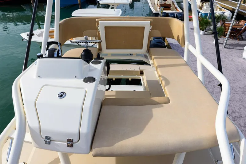 Slide: The Image of Manufacturer Provided Image: 2018 Scout 420 LXF boat interior with beige seating and control panel. - 9