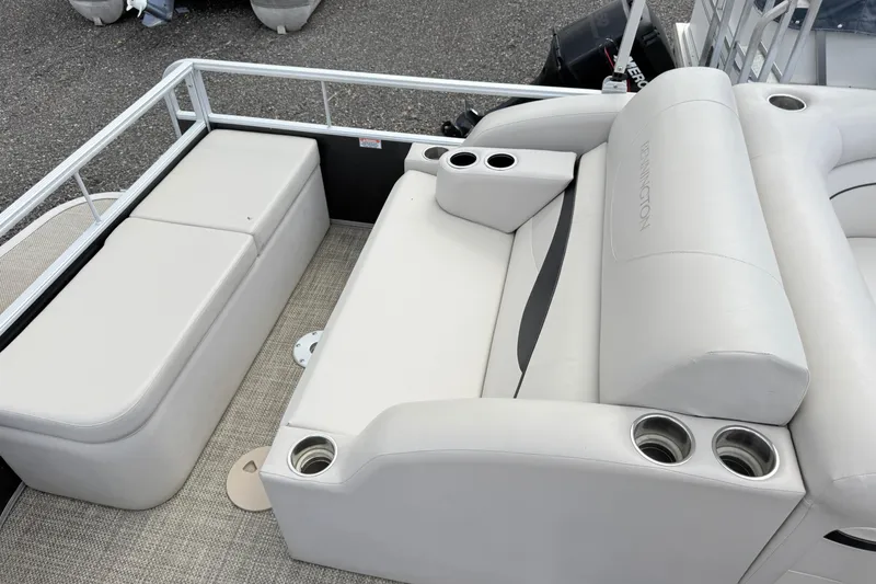 Slide: The Image of 2015 Bennington 24SSLX pontoon boat interior with white seating and cup holders. - 11