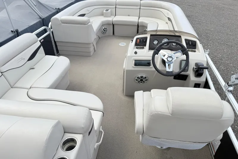 Slide: The Image of Luxurious interior of a 2015 Bennington 24SSLX pontoon boat with plush seating and modern controls. - 12