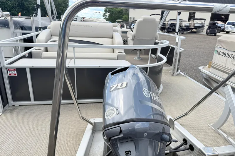 Slide: The Image of 2015 Bennington 24SSLX pontoon boat with Yamaha 70 outboard motor, docked outdoors. - 13