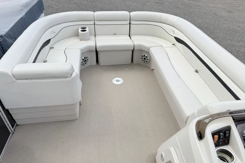 Slide: The Image of 2015 Bennington 24SSLX pontoon boat interior with white seating and cup holders. - 3