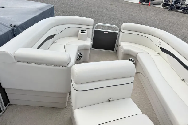 Slide: The Image of 2015 Bennington 24SSLX pontoon boat interior with white seating and cup holders. - 6