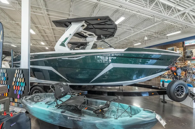 The Image of 2026 Tigé Z3 boat displayed in showroom with kayak and color samples. - 1